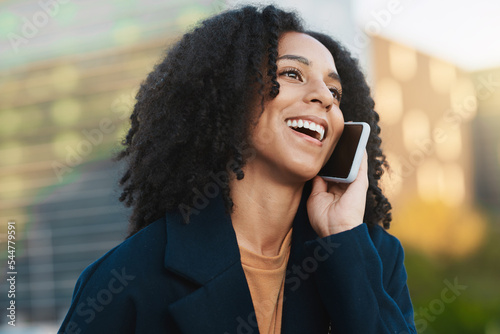 Phone, woman and phone call in a city by business woman, happy and excited by good news, promotion or success with startup goal. Black woman, call and entrepreneur laughing, cheerful and networking