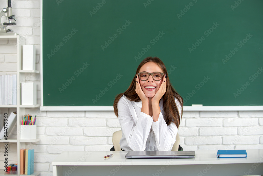 Portrait of smiling young college student studying in classroom. Happy school girl. Portrait of smiling young college student studying in classroom. Happy school girl.