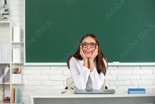 Portrait of smiling young college student studying in classroom. Happy school girl. © Volodymyr