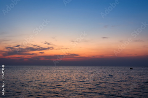 Calm sea with sunset sky and sun through clouds above. sky ocean meditation calm sea horizon over water © woottipong kokarat