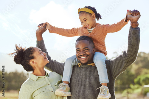 Lifting, smile and fun happy family play, bond or enjoy outdoor quality time together. Love, summer freedom or excited black father, mother or parents with kid girl with happiness on holiday vacation #544781348