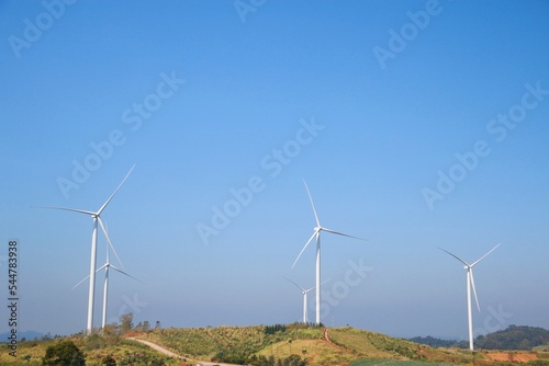 Landscape with hills and wind turbines and blue sky backgound. 