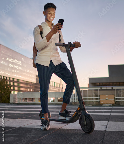 Businessman, electric scooter or phone at city travel sunset by New York buildings on location map. Happy smile, designer or escooter transport, environment and carbon footprint transport with mobile photo