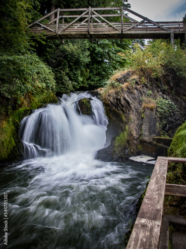 Waterfall under bridge in Washington state in summer