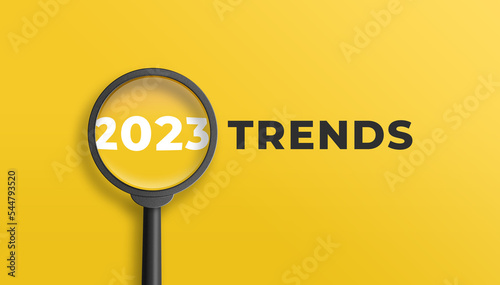 Magnifying glass magnifies 2023 trends on yellow background. Focusing on the year 2023 for technology trends update concept. 3D illustration. photo