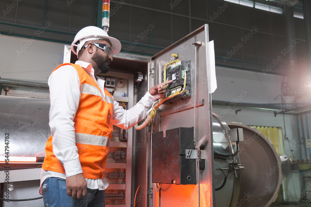 South Asia male factory worker or Man engineer or expert staff is maintenance and checking control system South Asia male factory worker or Man engineer or expert staff is maintenance and checking control system