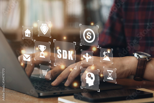 Businessman using a computer to SDK Software development kit programming language technology concept on virtual screen..