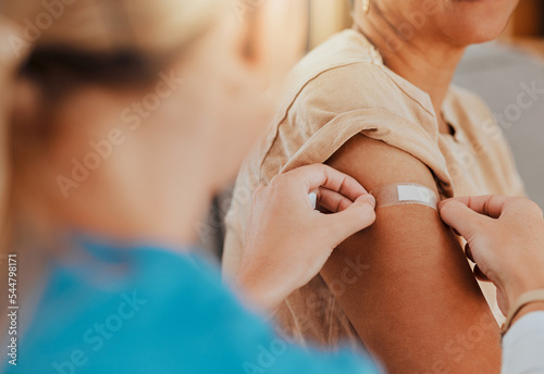 Healthcare, patient and plaster on arm for covid vaccine, flu shot or arthritis or osteoarthritis injection in hospital for health and wellness. Woman and nurse or doctor together during consultation photo