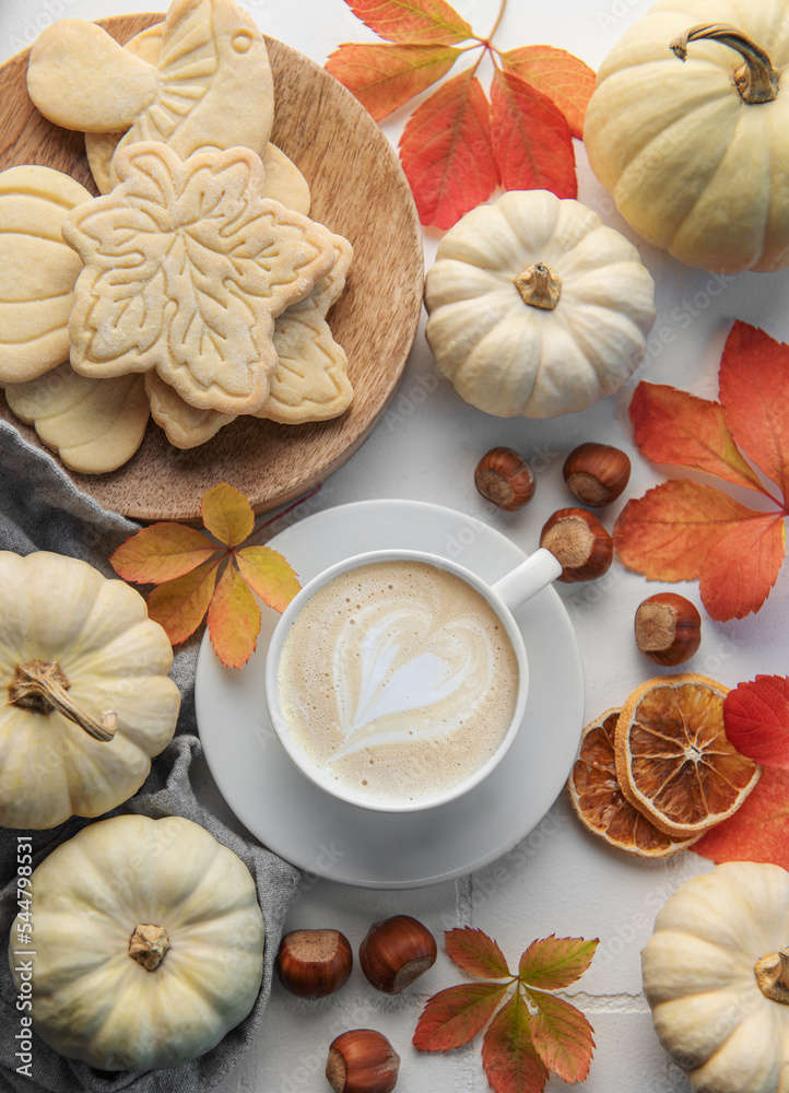 custom made wallpaper toronto digitalHot coffee with cookies in a white cup surrounded by autumn leaves and pumpkins on a white wooden background.