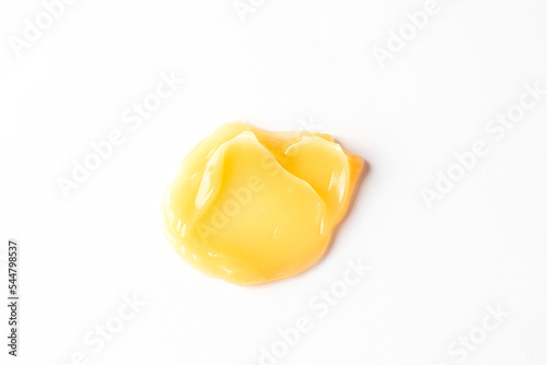 Yellow gel serum swatch texture on white background. Cleanser swatch smear. Cosmetic beauty product sample
