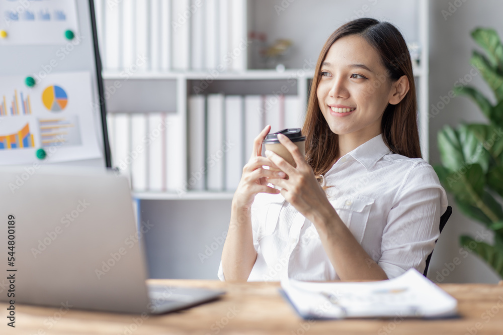 Business woman using calculator for do math finance on desk in Home office, Asian female finance business tax, accounting, statistics and analytic research concept Business woman using calculator for do math finance on desk in Home office, Asian female finance business tax, accounting, statistics and analytic research concept