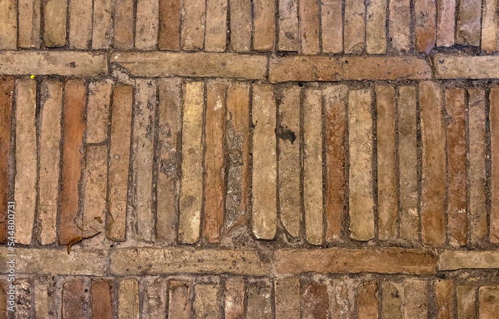 Background texture of terracota brick tiles used in a path in Italy
