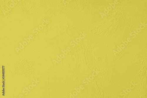 Saturated yellow colored low contrast Concrete textured background with roughness and irregularities. 2020, 2021 color trend.