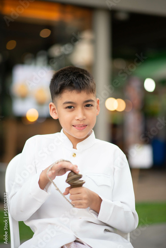 Asian boy play Ching finger cymbals played in Cambodian and Thai theater and dance ensembles