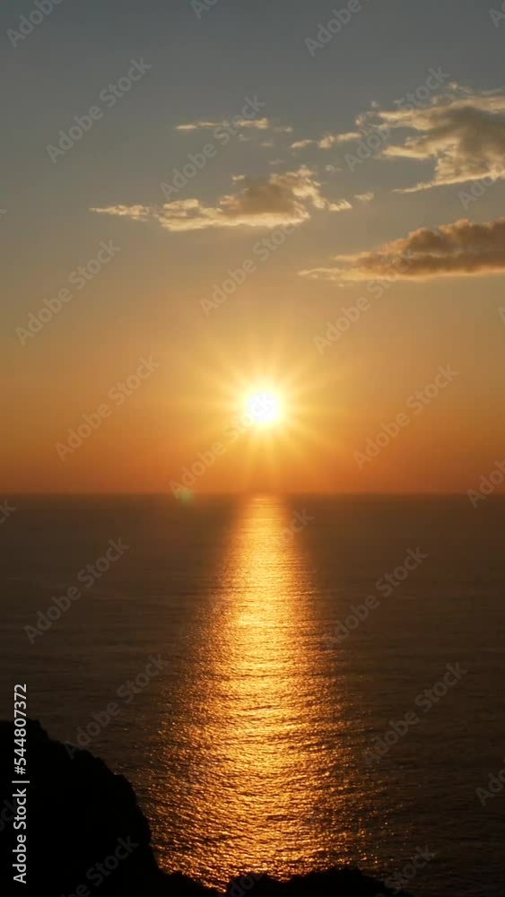 Scenic view of the golden sunset over the waves.  Vertical video frame 9x16