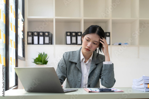 asian woman thinking hard concerned about online problem solution looking at laptop screen, worried serious asian businesswoman focused on solving difficult work computer task