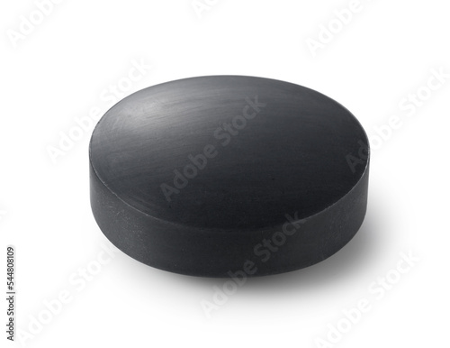 Black solid soap placed on a white background.