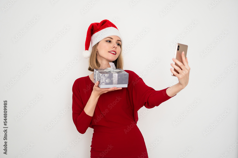 portrait of stylish European woman in a red dress with gift boxes and smartphone for holiday isolated on white background portrait of stylish European woman in a red dress with gift boxes and smartphone for holiday isolated on white background