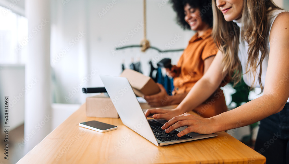 Two online business owners working together in their shop Two online business owners working together in their shop