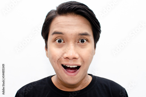 headshot of shocked, surprised, amazed young asian man in black tshirt isolated over white