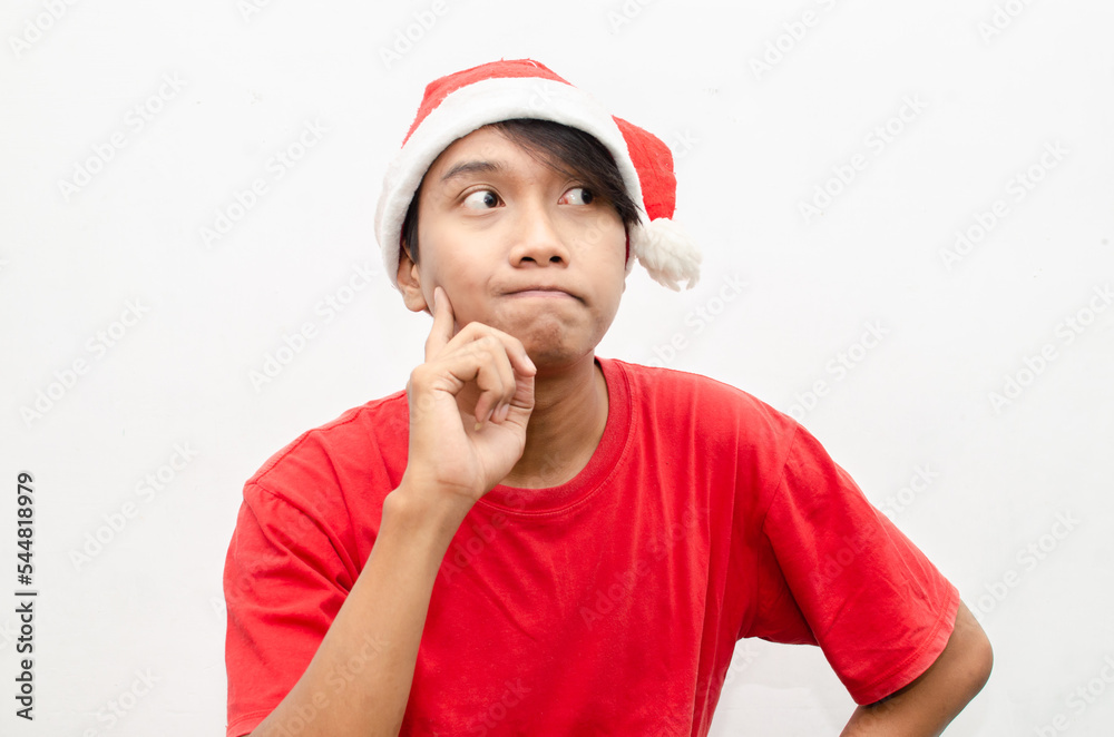 happy thinking asian man in christmas santa theme clothes with gesture of thinking and wondering. christmas model concept for sale and discount.