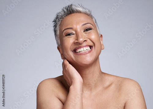 Mature woman, laughing or skincare face glow on grey studio background mock up in wellness, healthcare or dermatology routine. Portrait, smile or beauty model and gray hair or happy facial expression