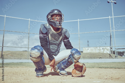 Baseball, fitness and catcher on a baseball field training for a sports game in an outdoor exercise workout in summer. Focus, wellness and healthy black man in safety gear with a secret hand gesture