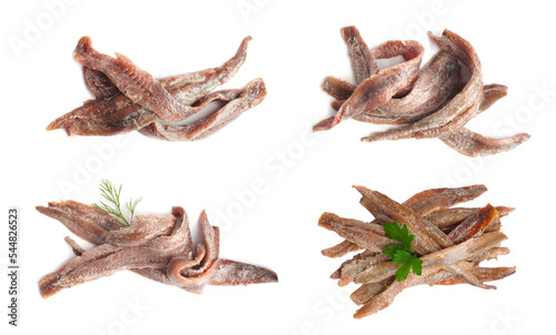 Set with delicious anchovy fillets on white background, top view