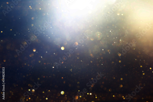 background of abstract glitter lights. gold, blue and black. de focused