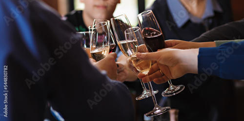 Ringing clinking of glasses at the table in a friendly company after a toast. Celebration of a solemn event or holiday