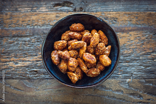 Photos Little handcrafted blue ceramic bowl filled with caramelized almonds and placed