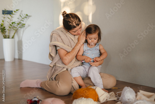The mother taking care of the development of her baby daughter's skills, practicing different hobbies. Happy mother or nanny engaged in hobby activity. Improve