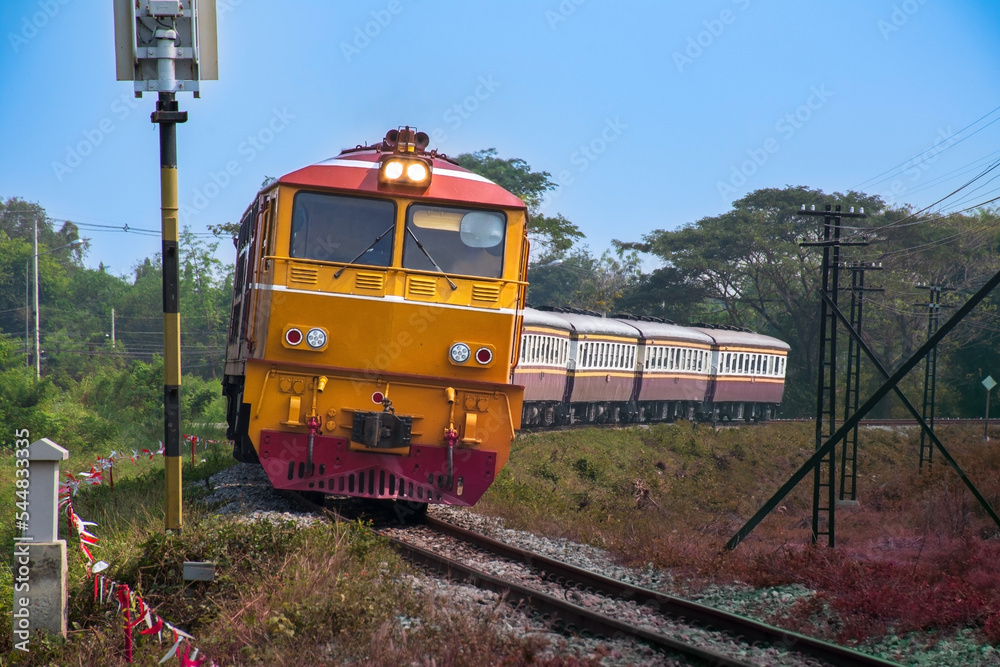 Obraz premium Passenger train by diesel locomotive passed the railway curve.