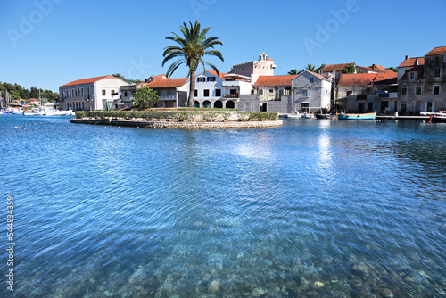 Sea channel in Vrboska village, Hvar island, Dalmatia, Croatia, Europe. Travel and vacation destination. Croatian old fishing and touristic village with stone houses reflected on the sea.