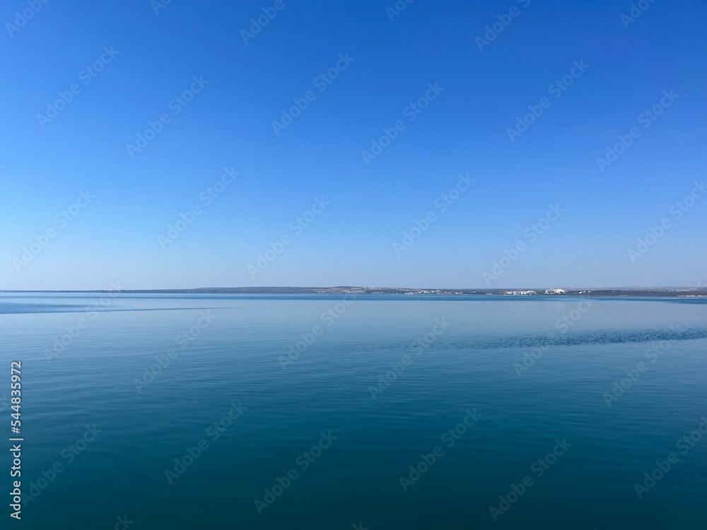 Blue sea horizon, clear blue sky and quiet sea surface