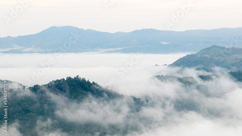 Aerial view of clouds on beautiful mountains that covers the fertile tropical forests South of Thailand.