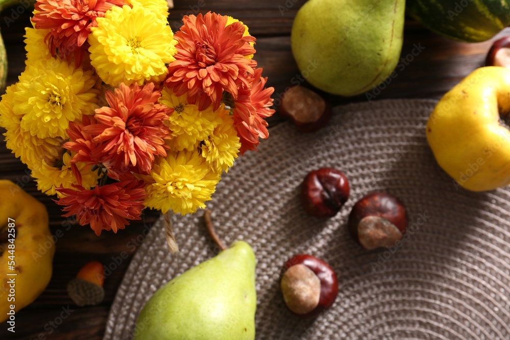 Autumn flat lay composition with beautiful chrysanthemum flowers and fruits on wooden table Autumn flat lay composition with beautiful chrysanthemum flowers and fruits on wooden table