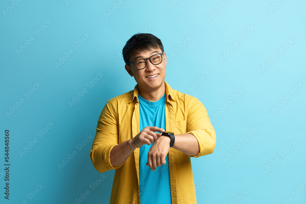 Asian Man Pointing Watch. Portrait of Cheerful Punctual Guy 
