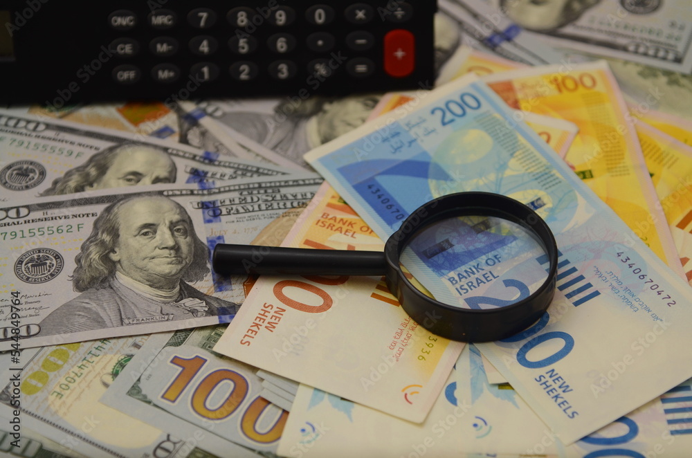 Lots of American dollars, a shovel and a calculator. Concept - a lot of money, jackpot, winning the lottery. Concept: money, profit. Lots of American dollars, a shovel and a calculator. Concept - a lot of money, jackpot, winning the lottery. Concept: money, profit.