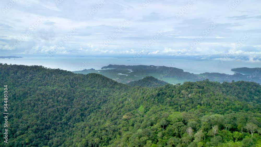 Aerial flyover Gunung Raya Mountain towards the northern mangroves in Malaysia Aerial flyover Gunung Raya Mountain towards the northern mangroves in Malaysia