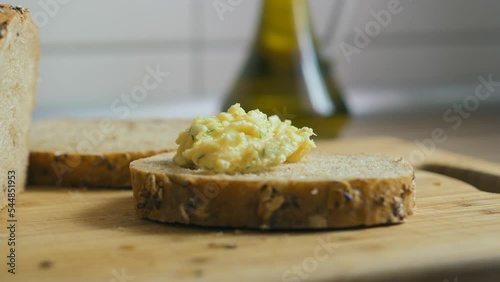 Making a sandwich with scrambled eggs and dill on a slice of bread. 
