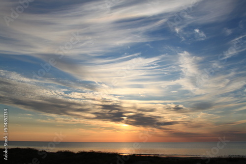 Beautiful evening sky above the sea before the sunset. Selective focus © Anna