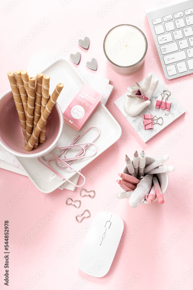 A feminine workspace, keyboard of a computer on pink background with copy space A feminine workspace, keyboard of a computer on pink background with copy space