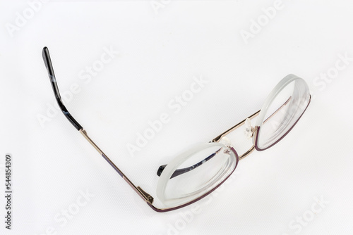 Classic eyeglasses in metal frame with one folded temple