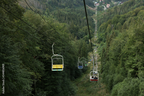 Ski lift and green trees at mountain resort © New Africa