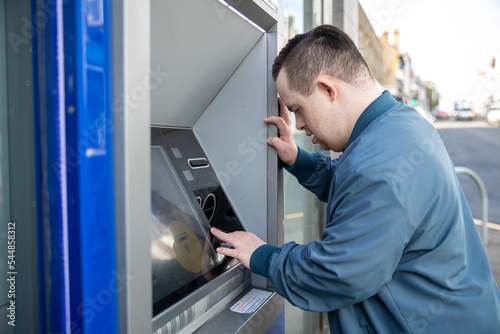 Man using cash machine in street