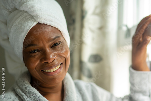 Fototapeta Portrait of smiling woman in towel turban