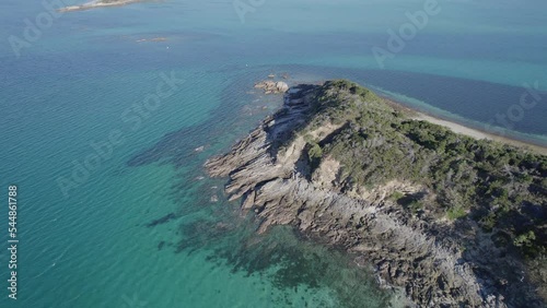 Aerial Pullback Over Middle Island Surrounded By Clear Blue Sea. Great Keppel (Wop-Pa) Island In Queensland, Australia. tilt-up reveal photo