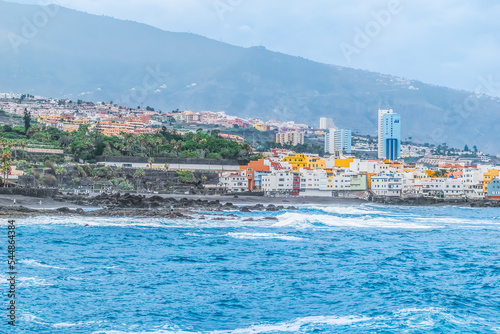 Puerto de la Cruz, Spain - November 25, 2021: Panorama of Puerto de la Cruz with Loro Park and Maritim Hotel on the coast of the Atlantic Ocean. Cityscape of the Canary Islands with black sand beach