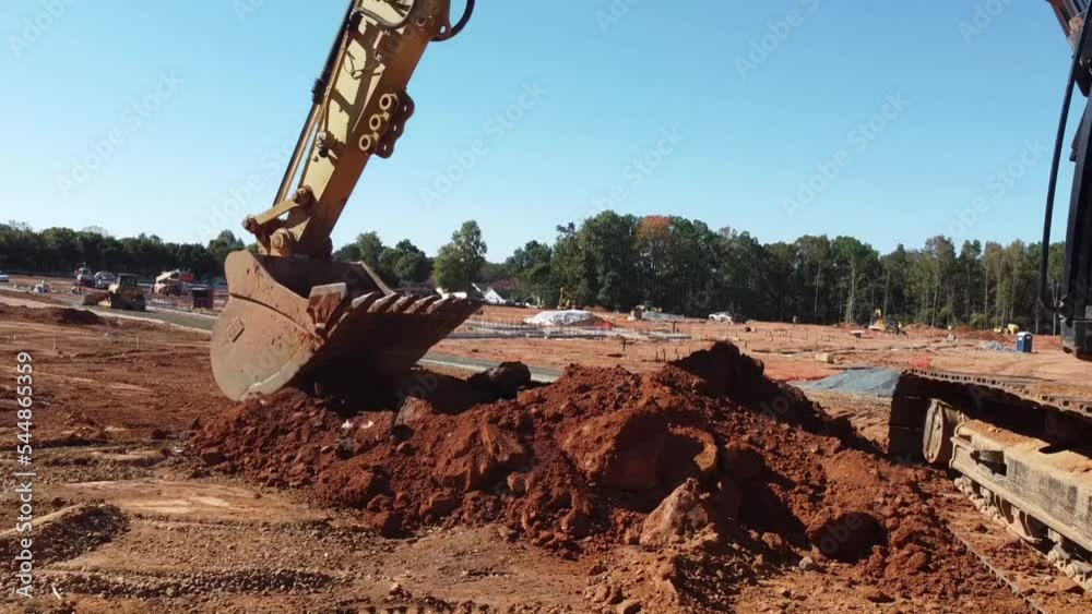 Excavator Digging Soil on Construction and Grading Site Fixed Camera